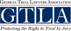 A blue rectangular logo with the white capital letters "GTLA" centered and a thin red border above and below the text.